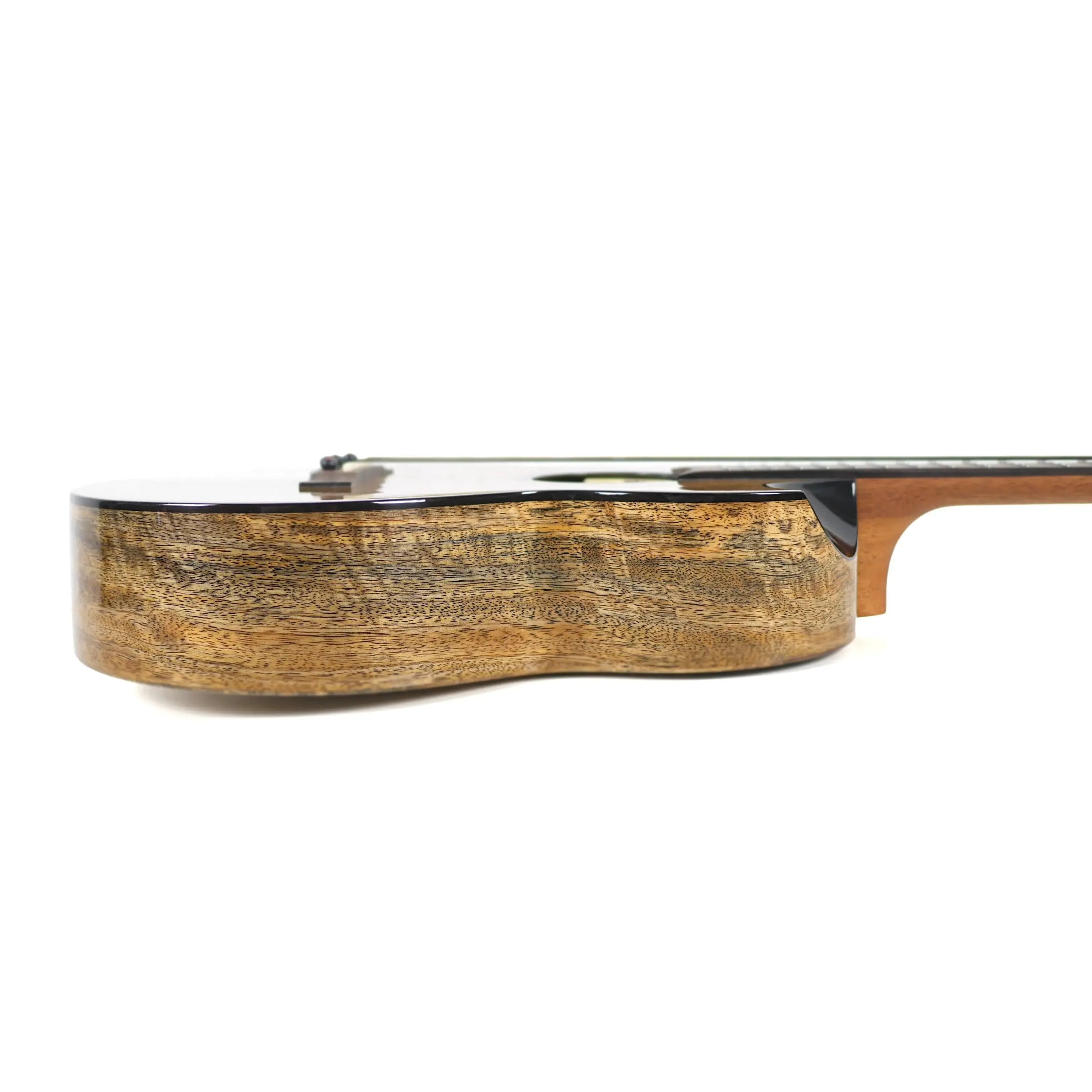Flight Fireball solid mango baritone ukulele, side view, showing gloss finish and wood grain.
