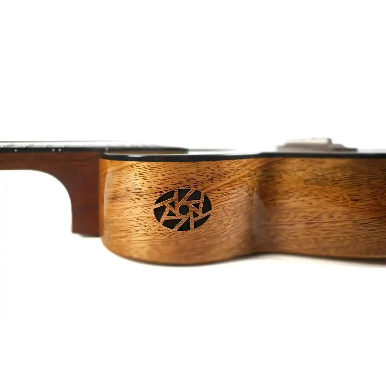 Side view of a Flight Fireball solid mango tenor ukulele body with a black circular logo.