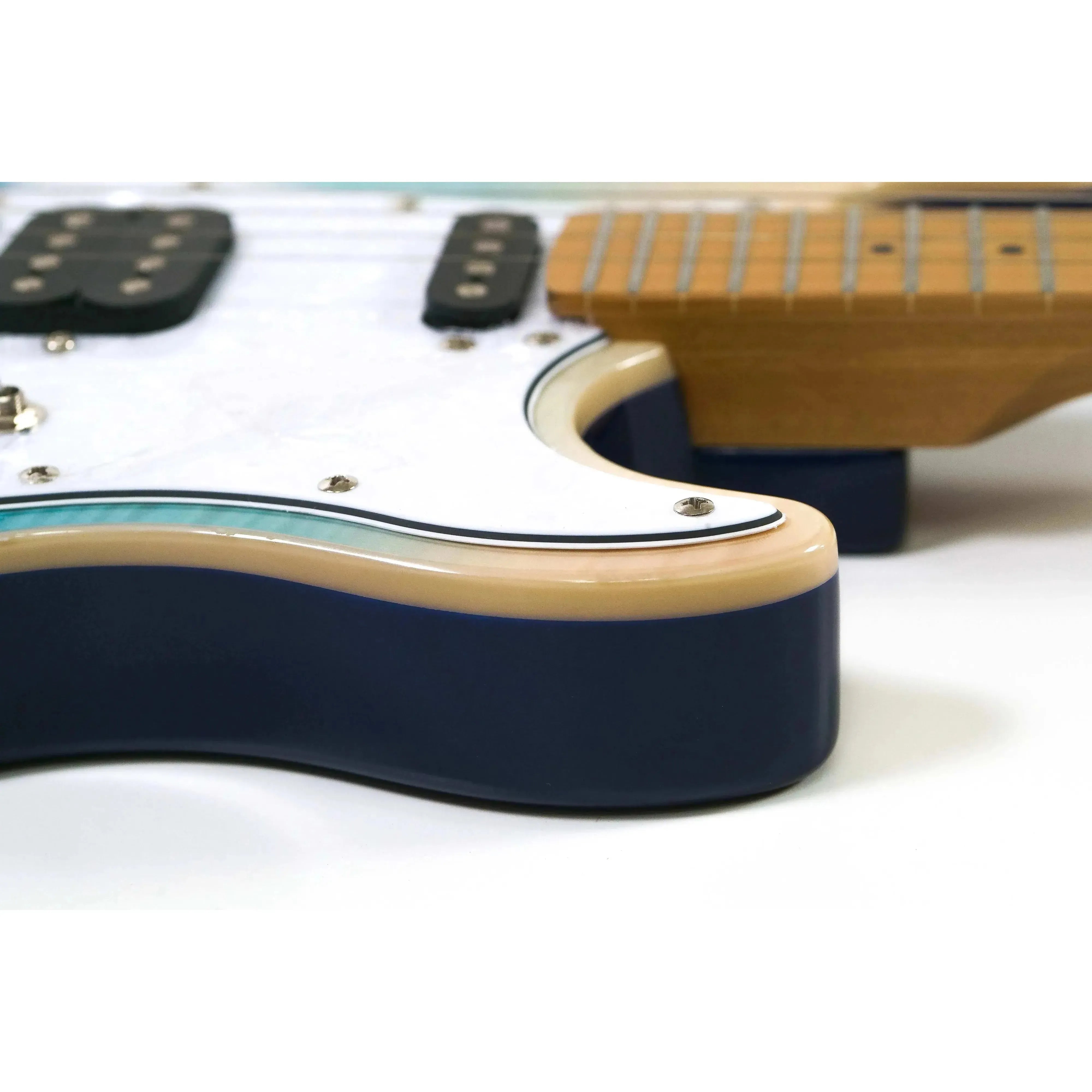 Close-up of a Flight Pathfinder TBL electric tenor ukulele's transparent blue body with white binding.