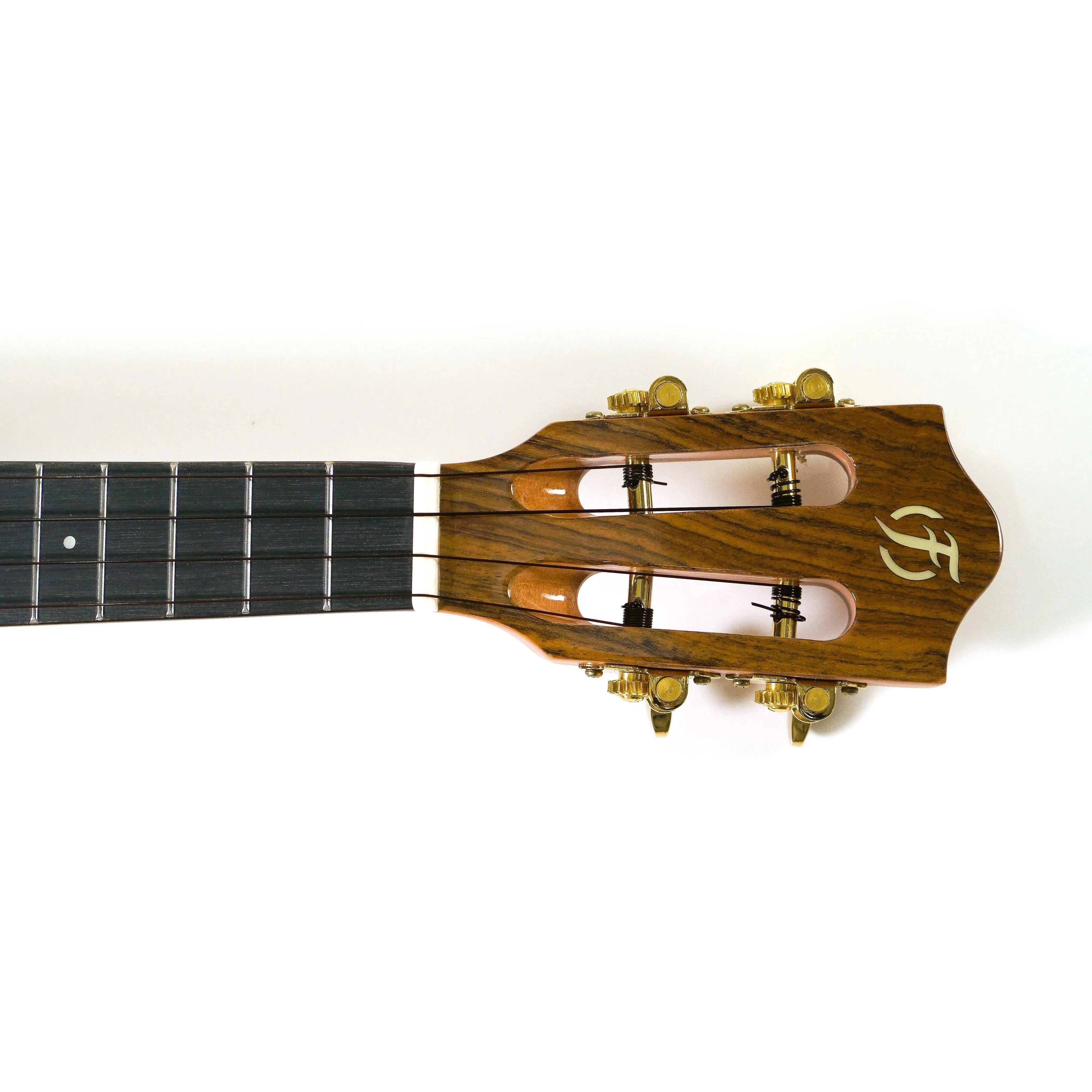 Flight Sophia TE Soundwave Tenor Ukulele headstock with golden tuners, bone nut, and purpleheart fretboard.