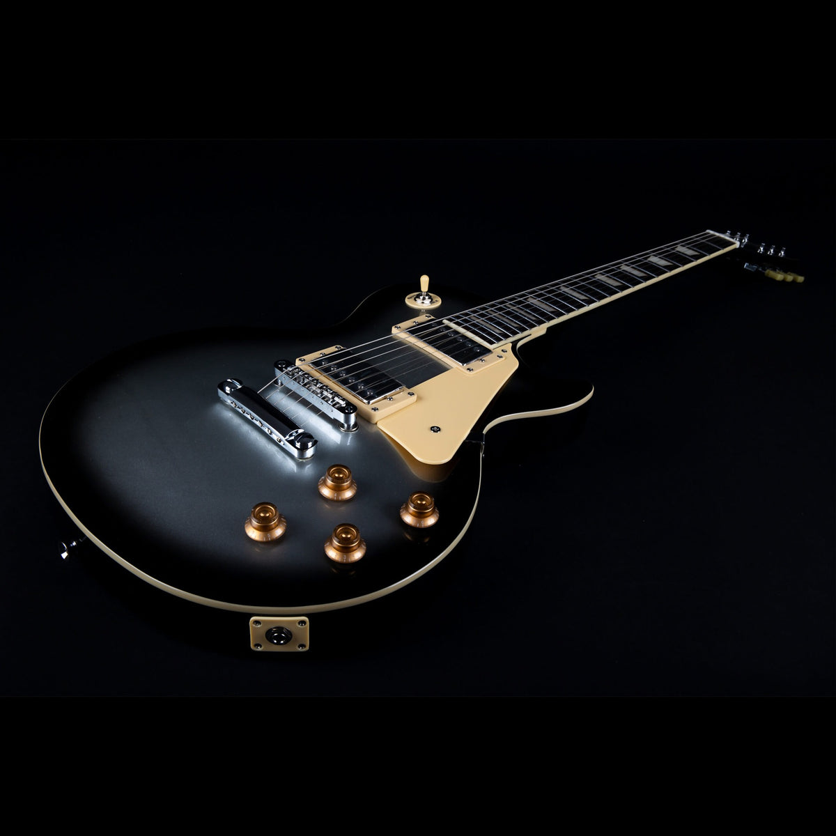 Jet JL-500 SLB Silverburst singlecut body angled view with stoptail bridge and cream pickguard.