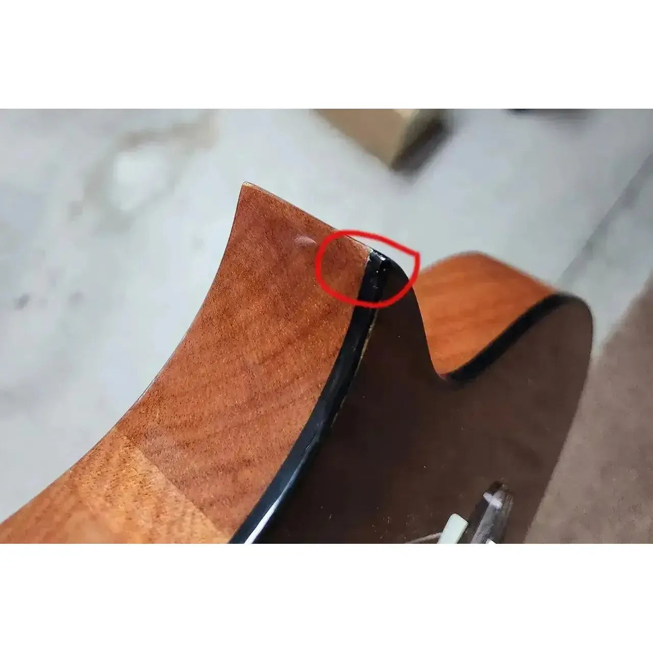 Kala Revelator Night Owl Acacia Tenor Ukulele cutaway with discoloration, circled in red.