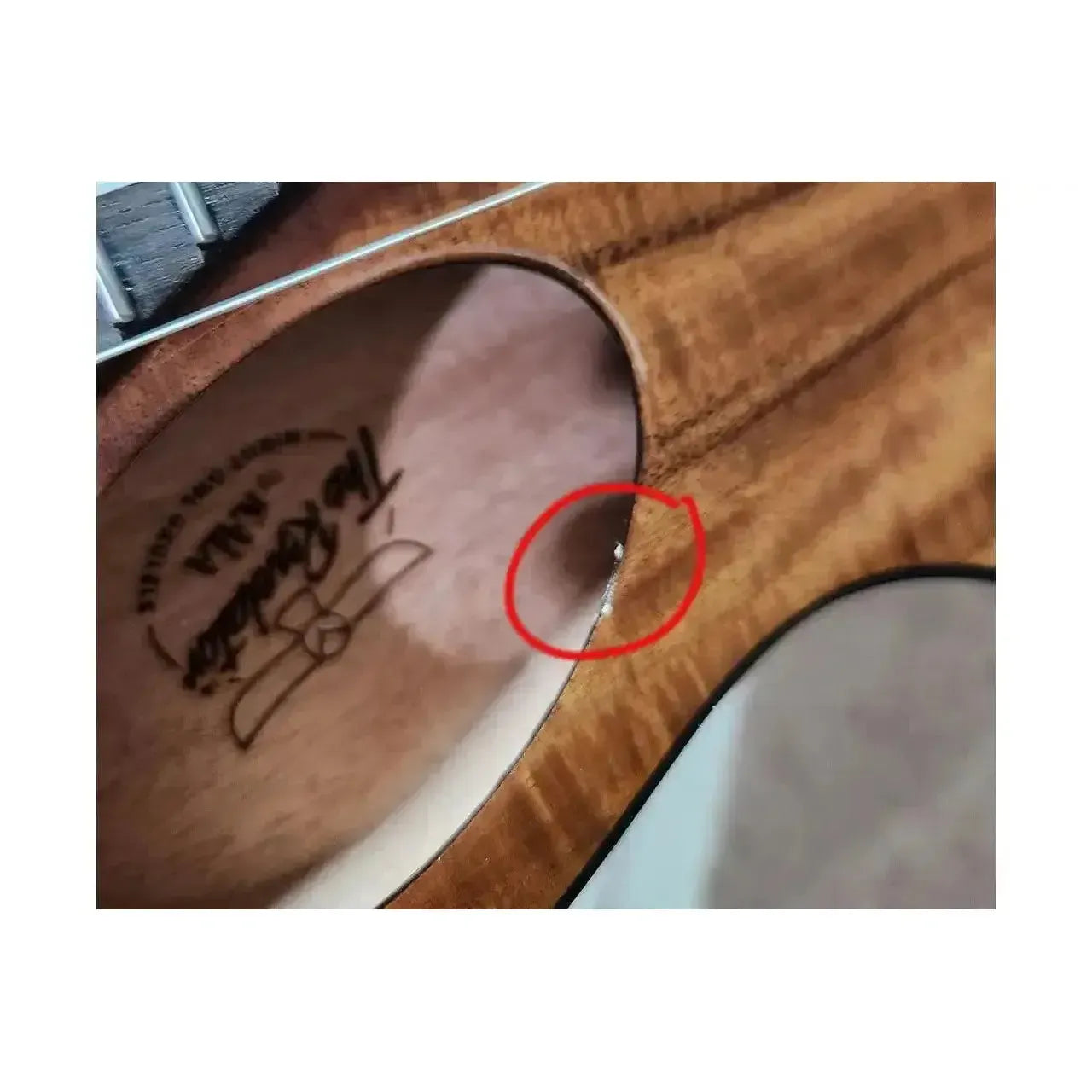 Close-up of Kala Revelator Night Owl Tenor Ukulele soundhole with highlighted glue residue.