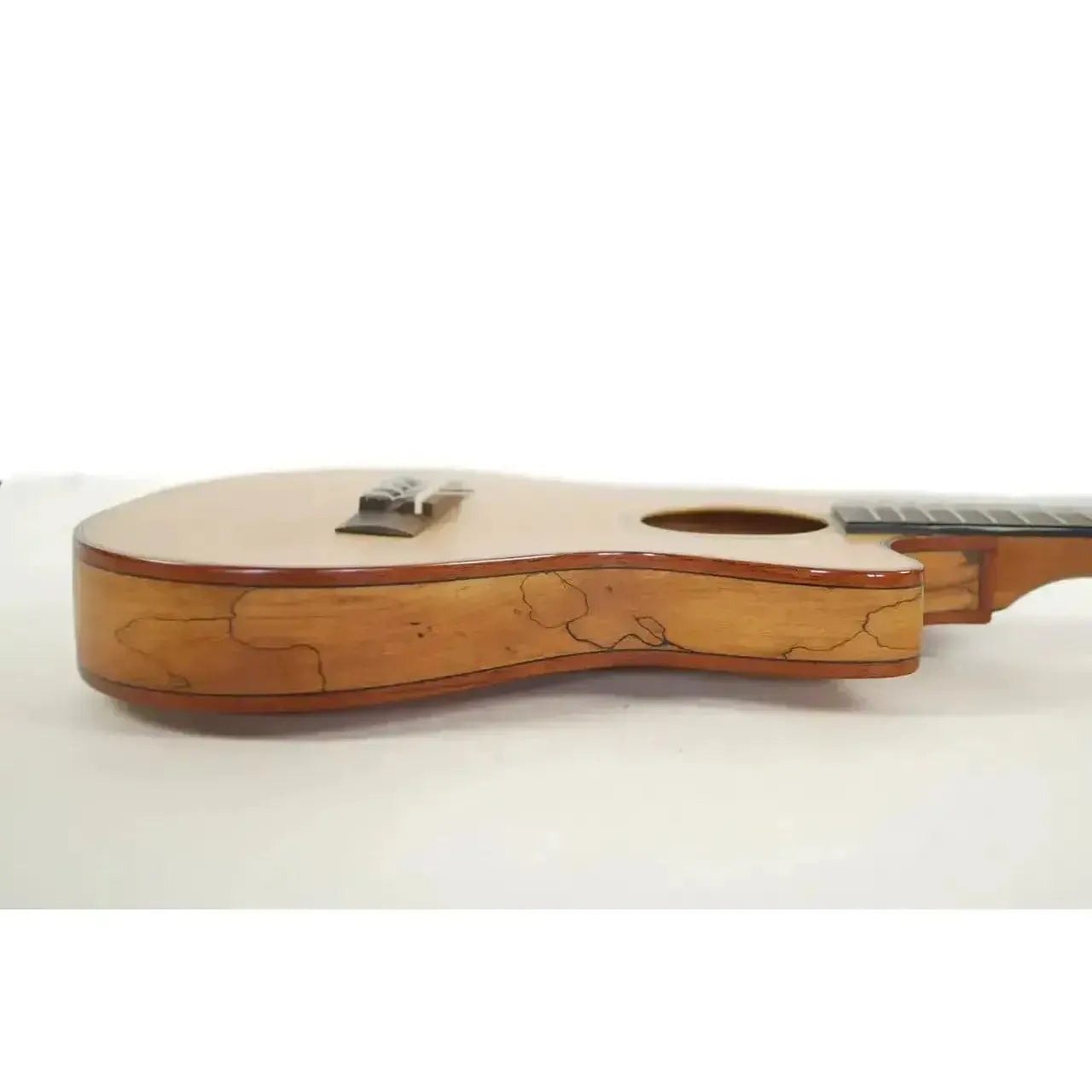 Kala Travel Thinbody Tenor Ukulele, side view showing light spruce top, flamed maple back, and thin body.