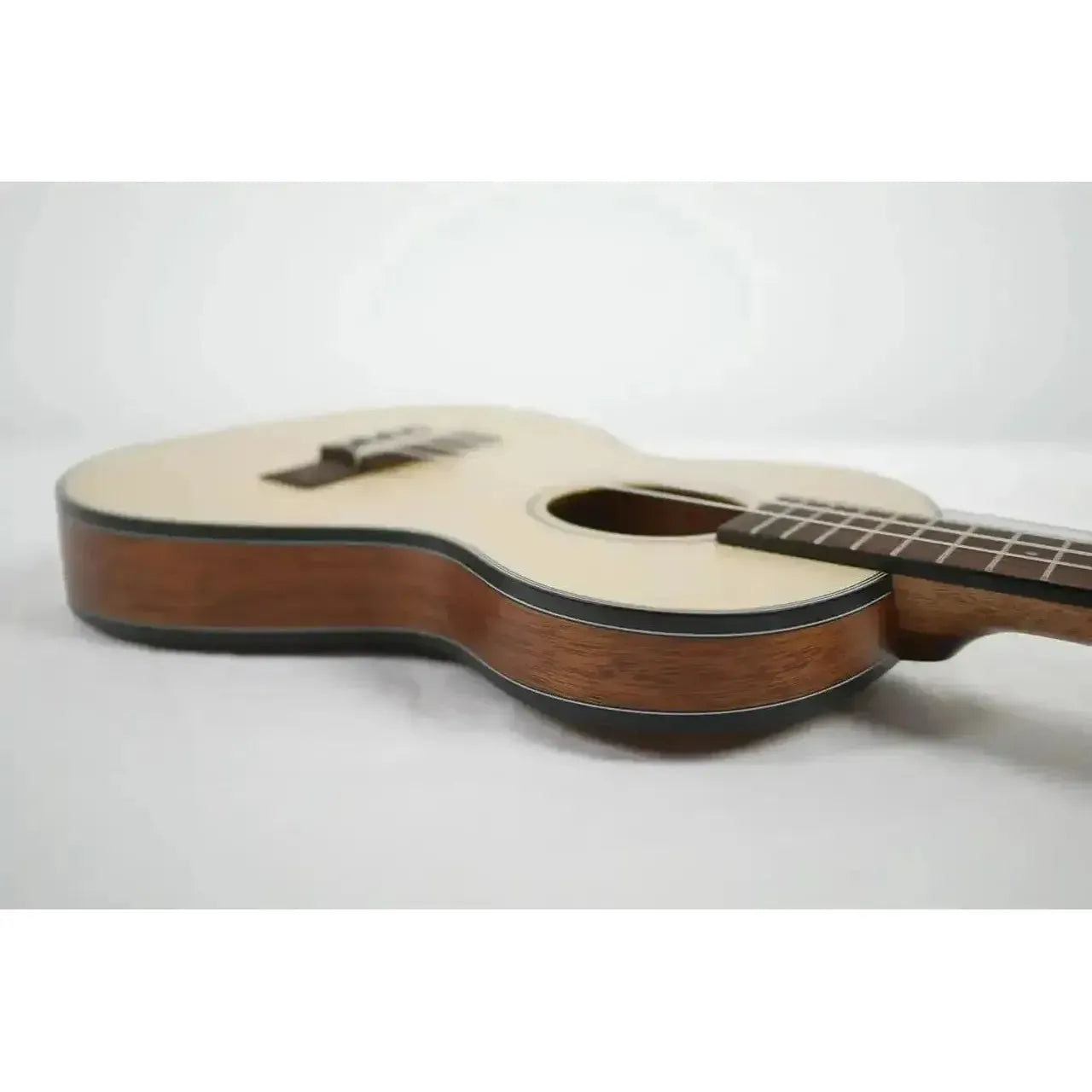Kala Travel Thinbody Tenor Ukulele with light spruce top and dark mahogany sides.