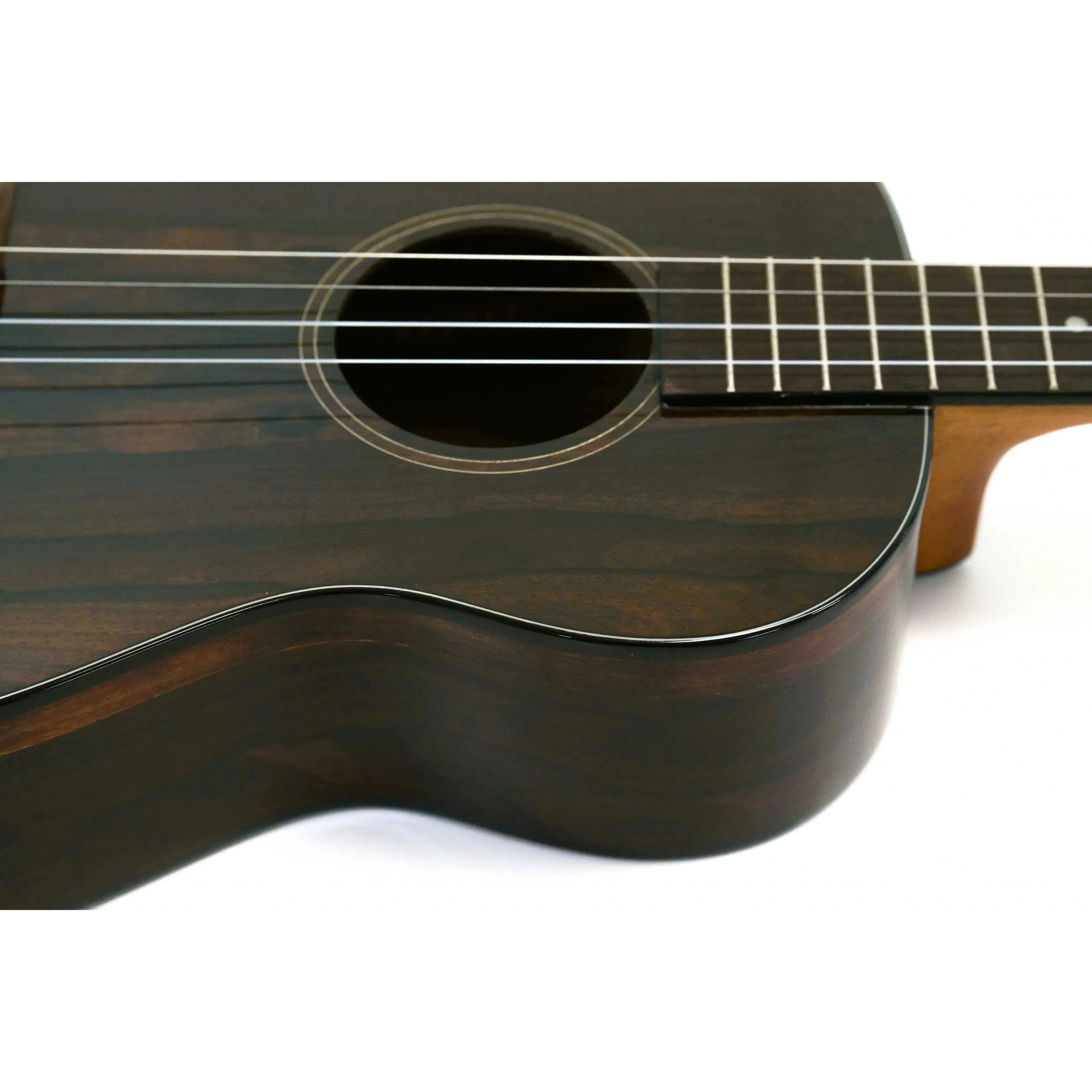 Kala ZCT-B Gloss Ziricote Baritone Ukulele body with dark wood grain, soundhole, and fretboard.