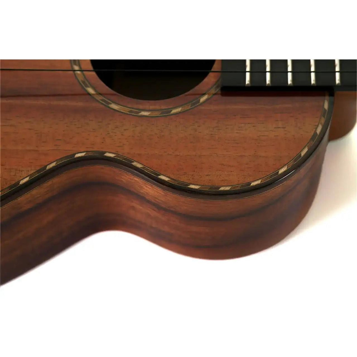 Kamaka HF-2-D concert ukulele close-up at an angle of the rope rosette, rope purfling and ebony fretboard