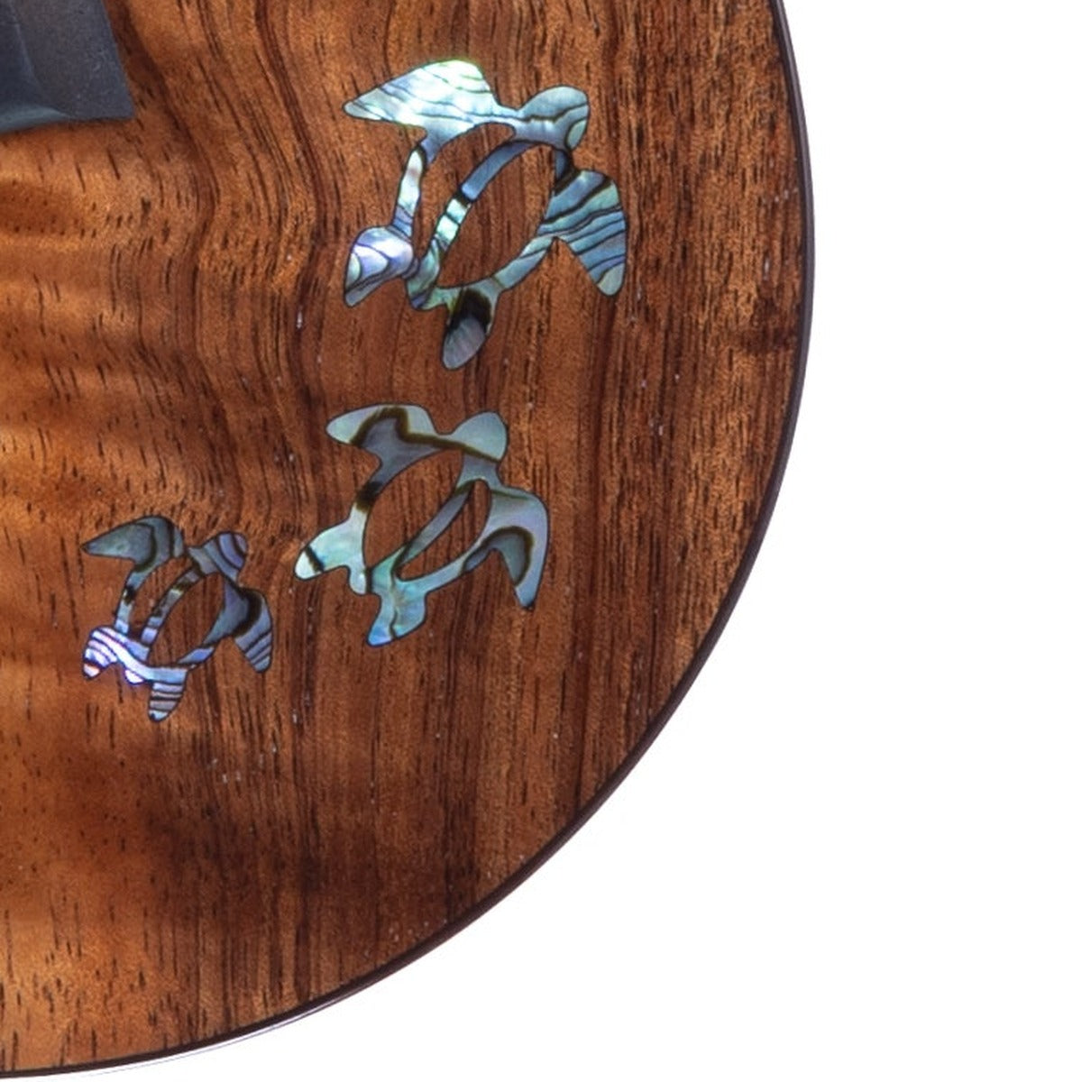Example photo: close-up of the three honu (sea turtles) inlaid in Paua abalone on the lower bout of a Kanile'a HNS Core, serial 29360