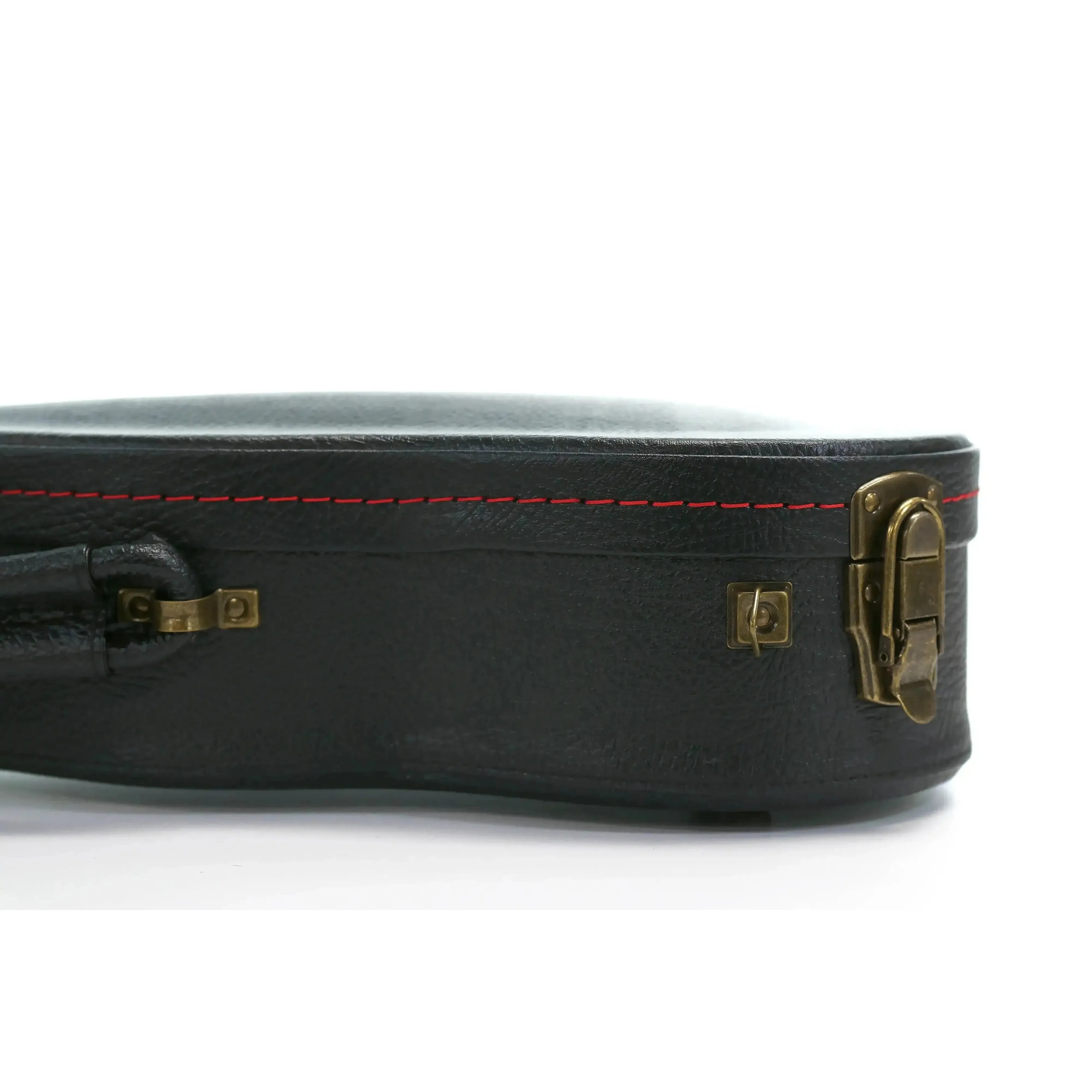KoAloha black tolex wood archtop concert ukulele hardshell case with vintage brass latches and red stitching.