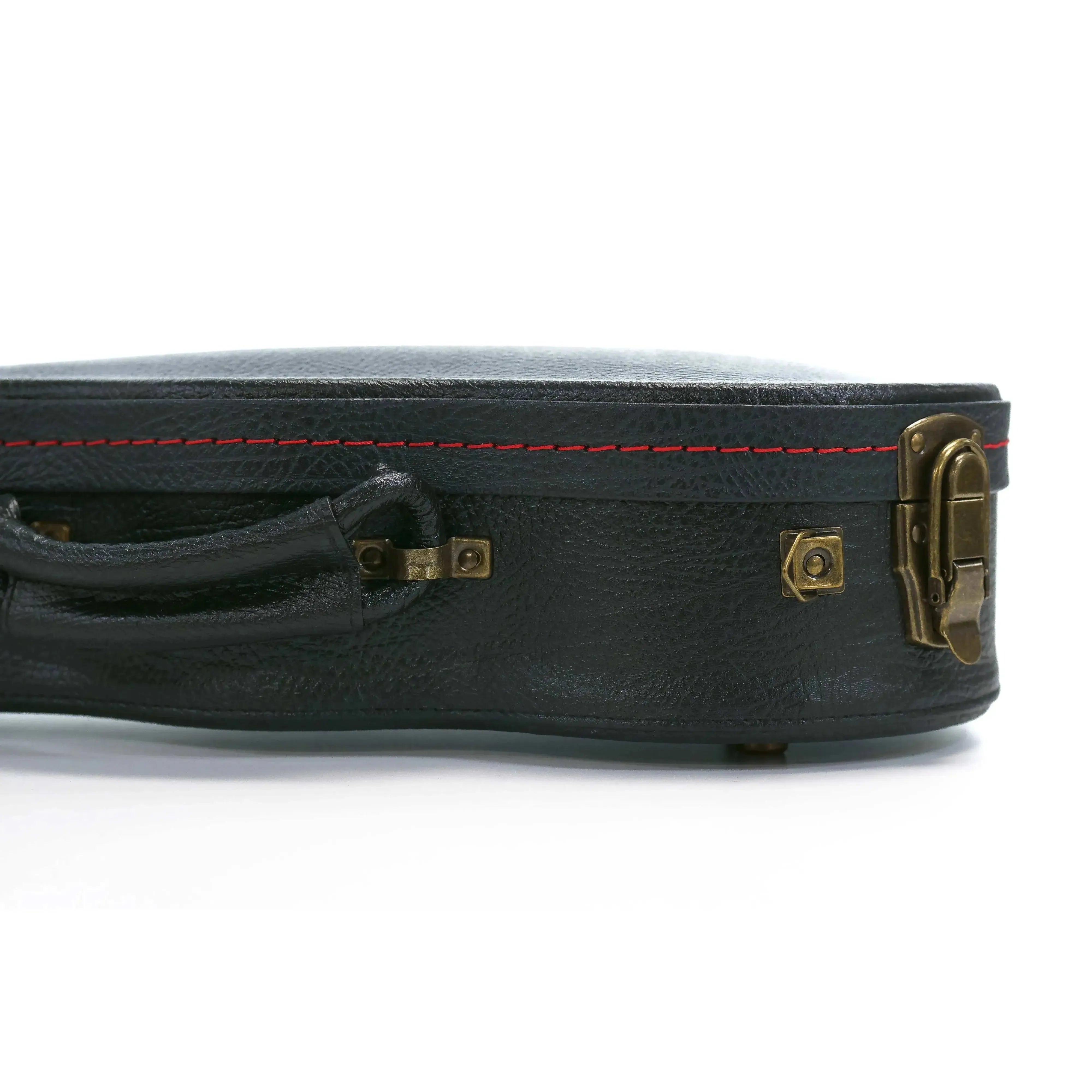 KoAloha black tolex soprano ukulele hardshell case with vintage aged brass latches and red stitching.