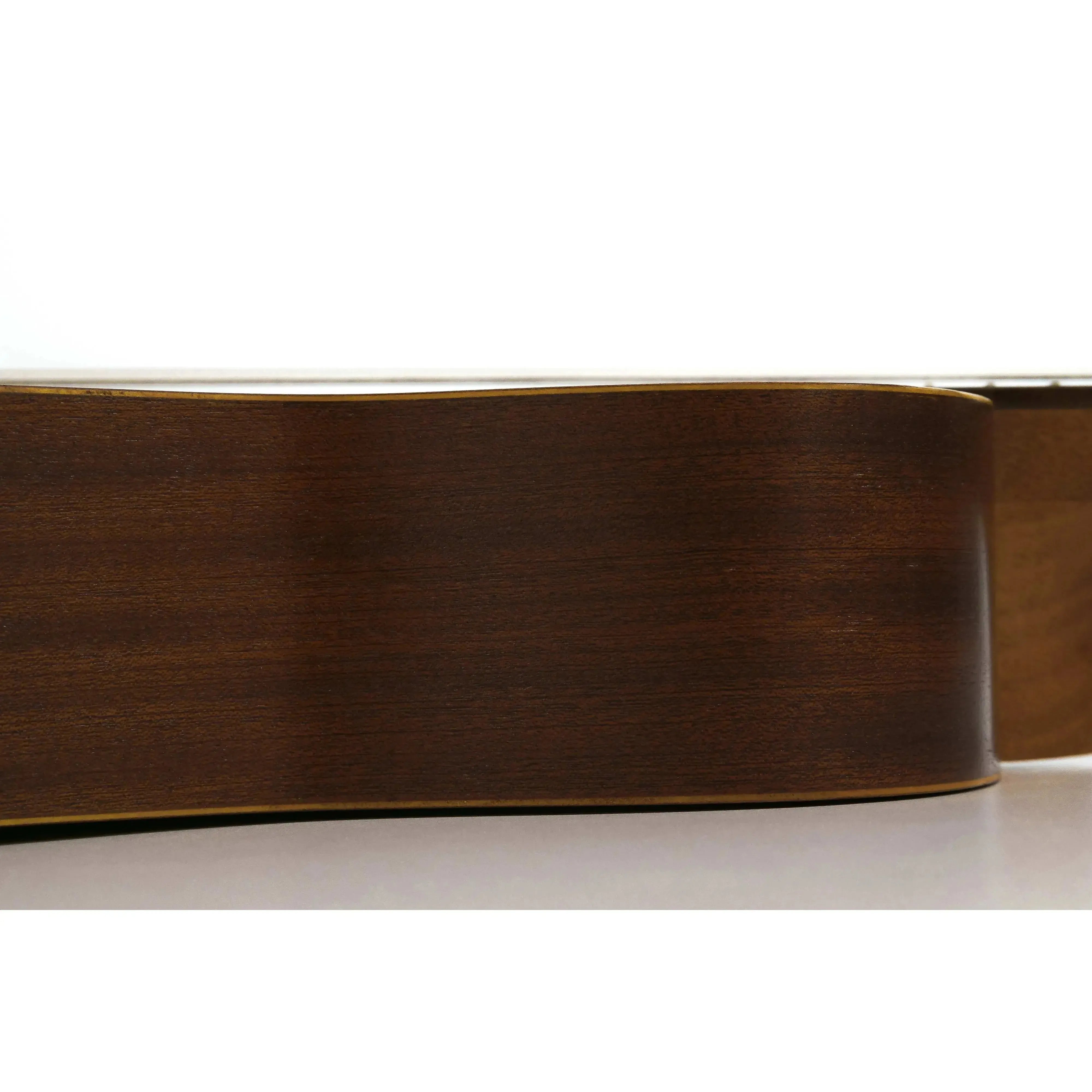 Side view of an Ohana BK-10 Baritone Ukulele, showing its dark mahogany body with satin finish and black binding.