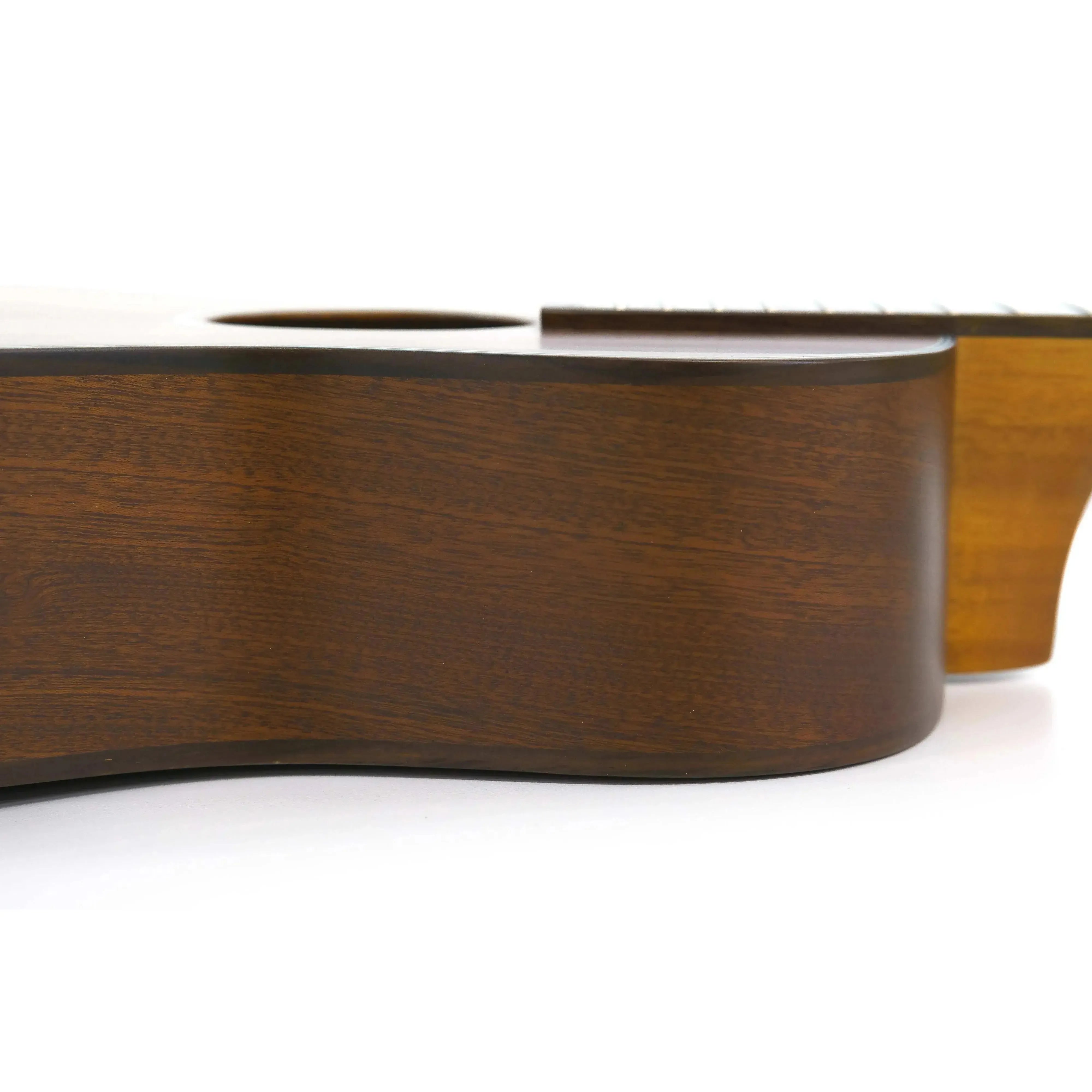 Side view of an Ohana BK-35 Baritone Ukulele, showing its solid mahogany body with a satin finish.