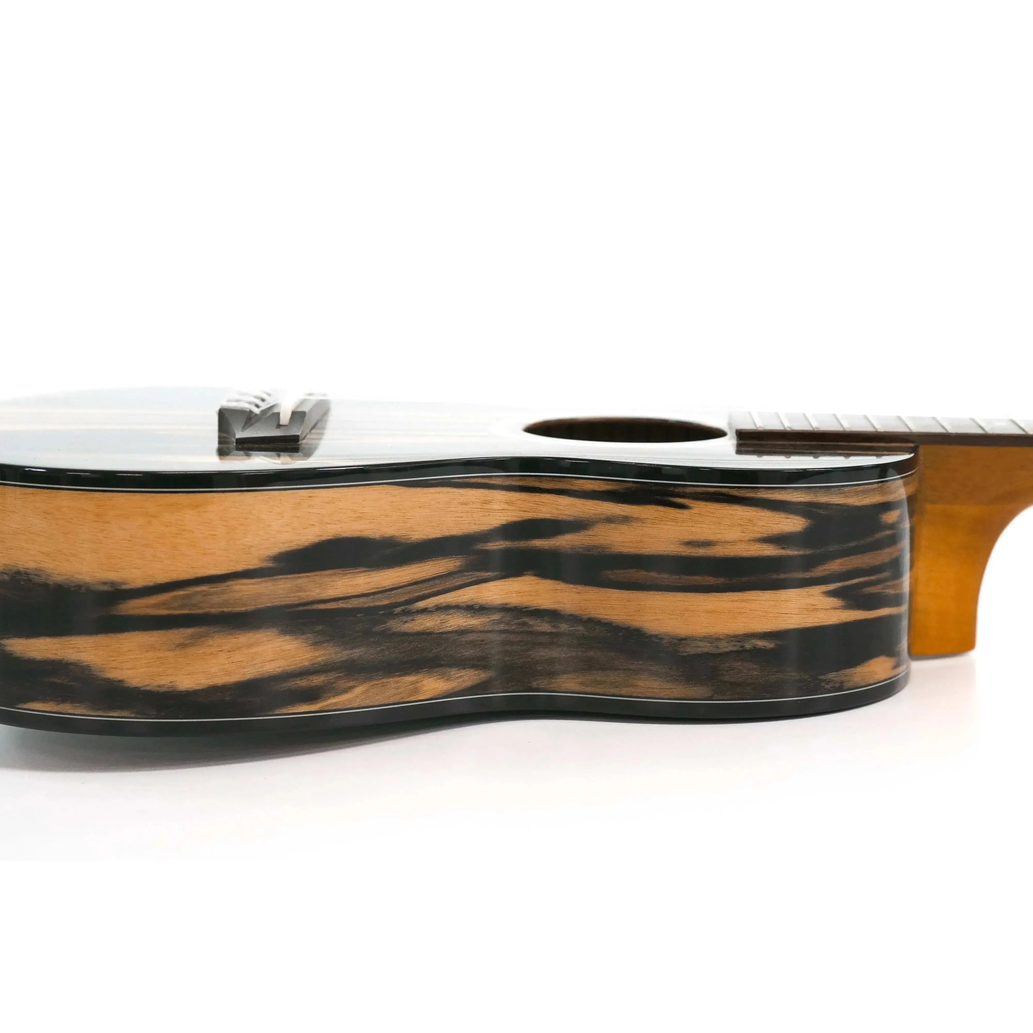 Ohana CK-150BWE Concert Ukulele side view, showing black and white ebony wood grain and glossy finish.
