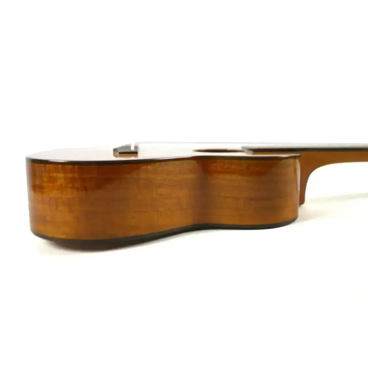 Side view of an Ohana CK-260G Concert Ukulele, showcasing its glossy solid acacia wood body.