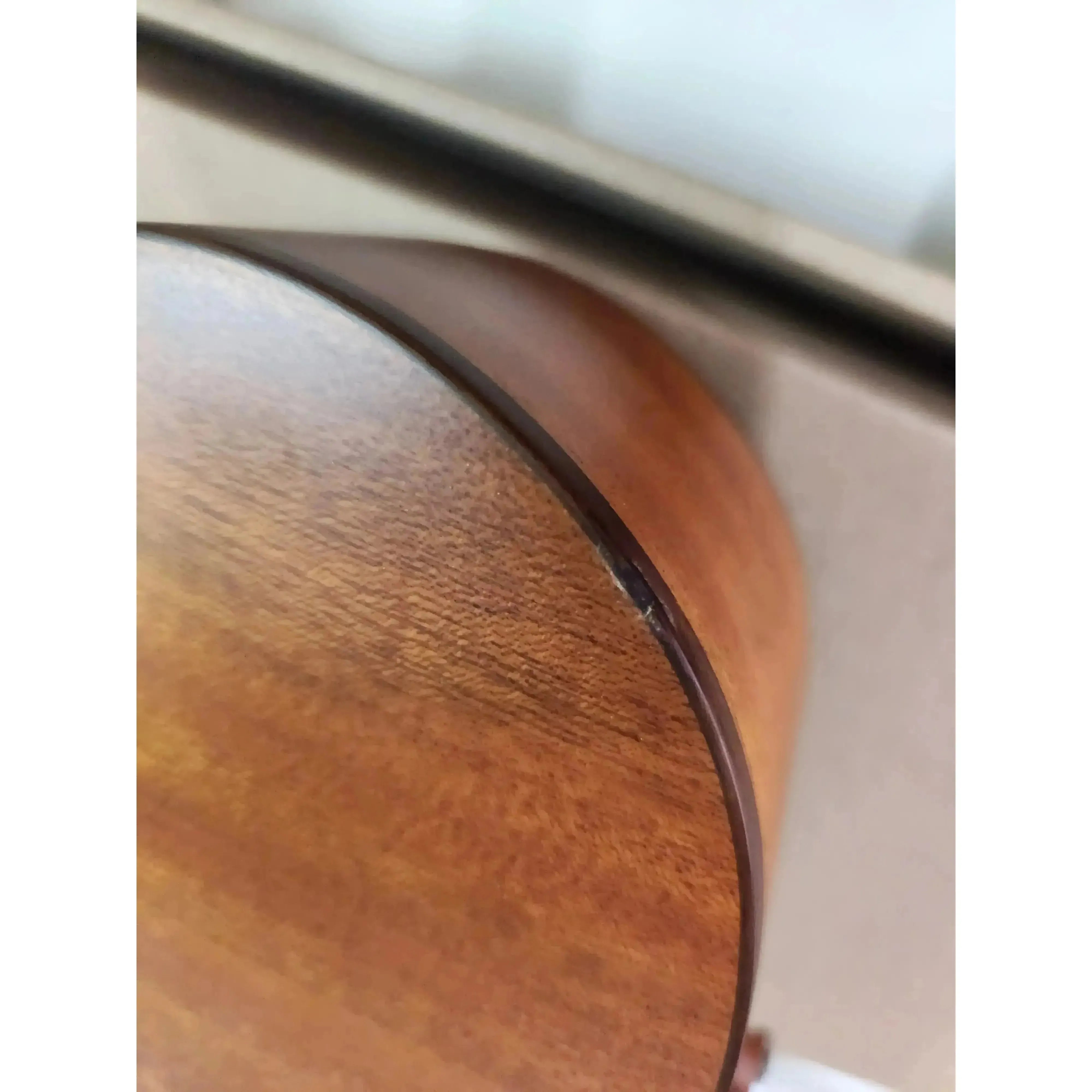 Close-up of the Ohana CK-35L longneck concert ukulele's solid mahogany body with satin finish and purfling.