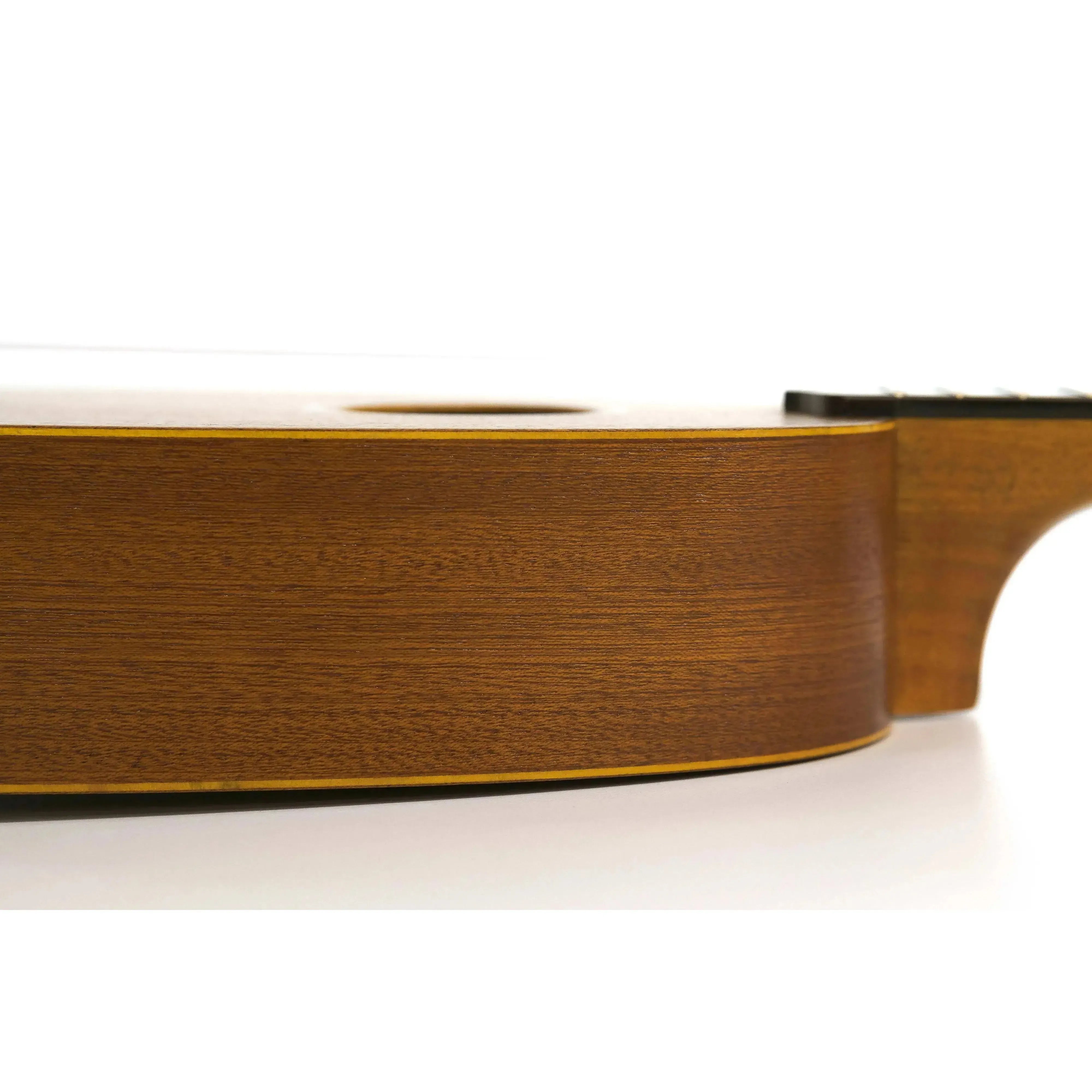Side view of an Ohana PK-10 Mahogany Pineapple Soprano Ukulele, showing its rich brown wood grain.