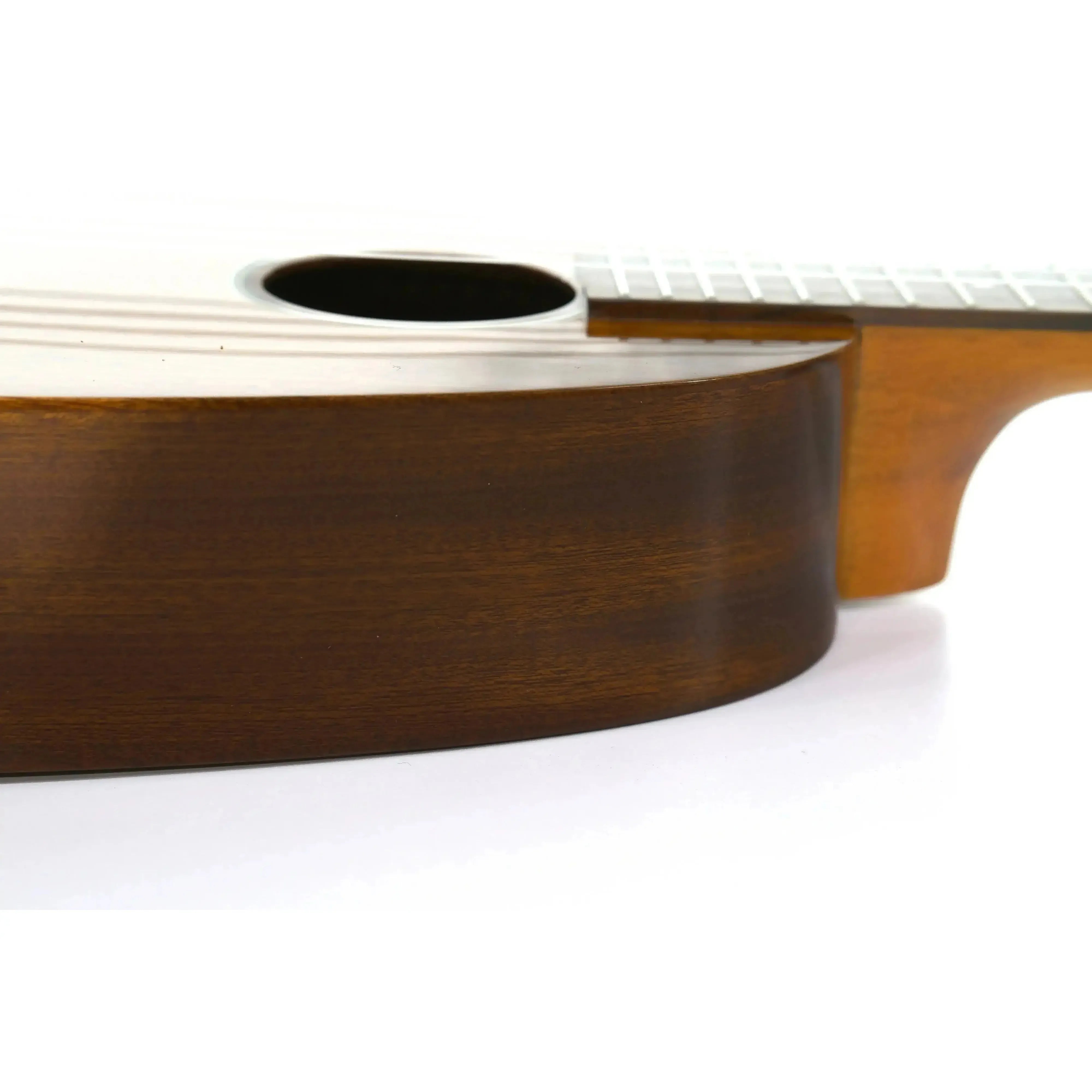 Side view of Ohana PKC-25G Pineapple Concert Ukulele body, showing solid mahogany and gloss finish.