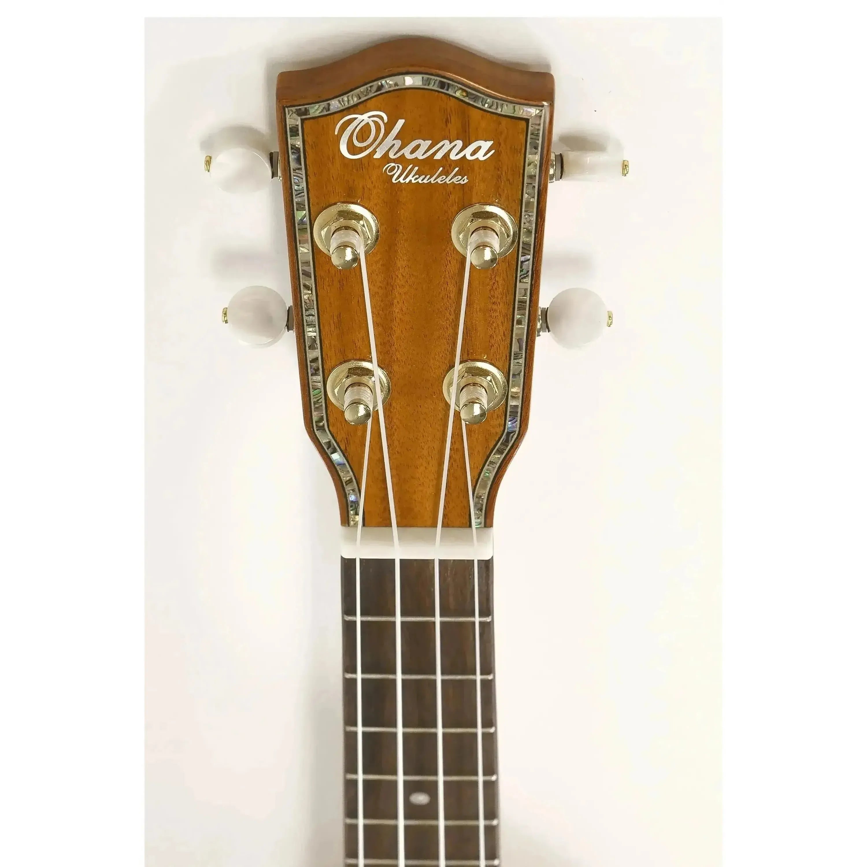 Ohana Gloss Solid Hawaiian Koa Tenor Ukulele headstock with abalone inlay, gold tuners, and white buttons.