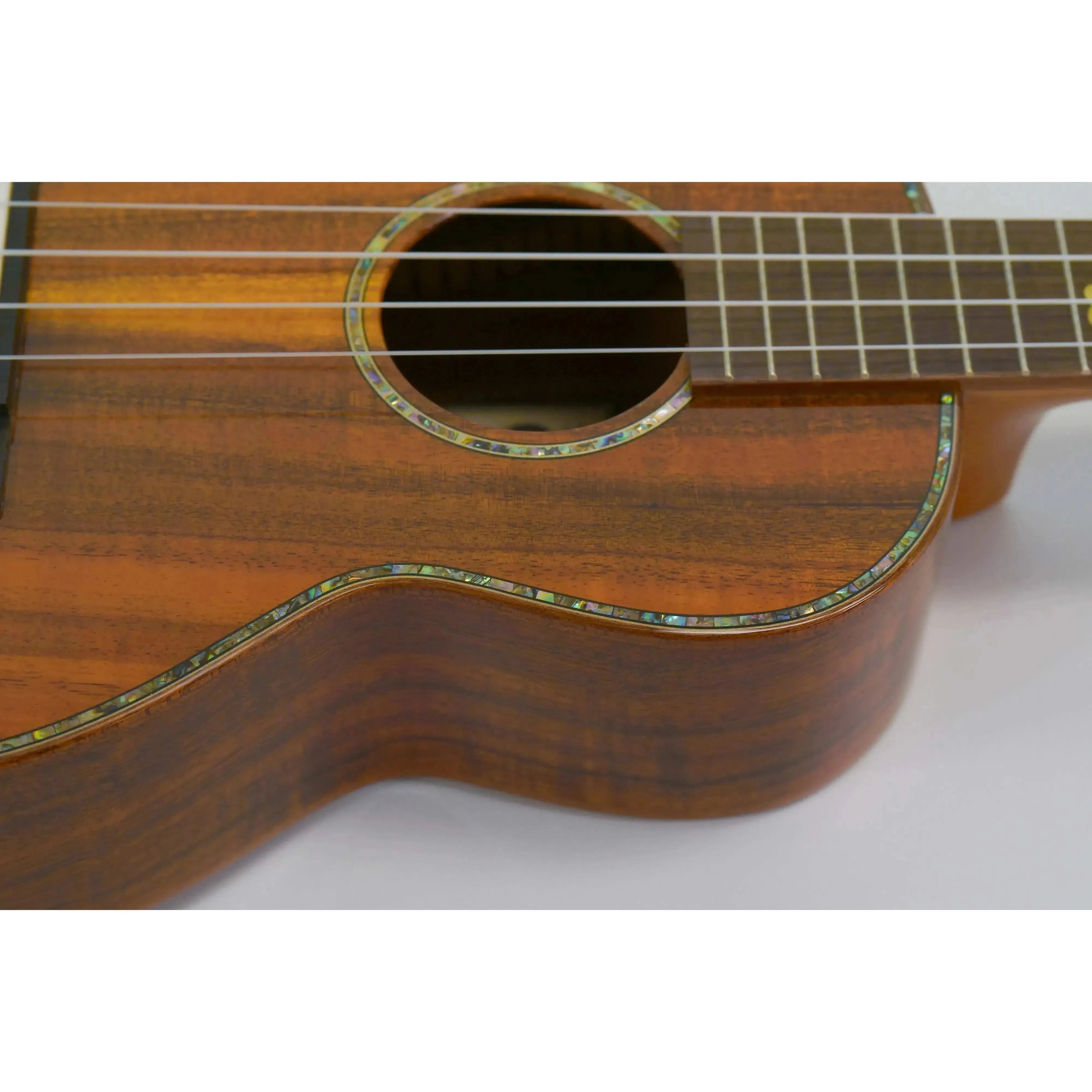 Ohana TK-370G Tenor Ukulele, close-up of gloss solid Hawaiian Koa body with abalone inlay.