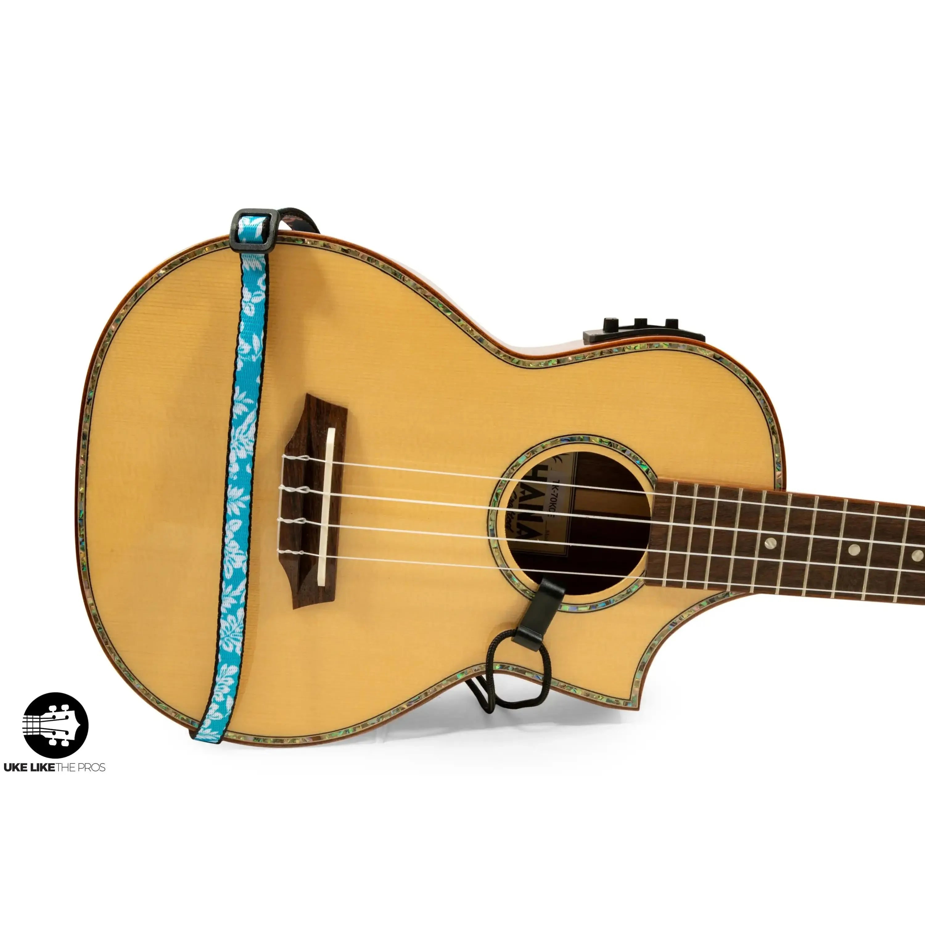 Ohana USS-04 ukulele sound hole strap, blue floral polyester, 0.5" wide, attached to a light wood ukulele.