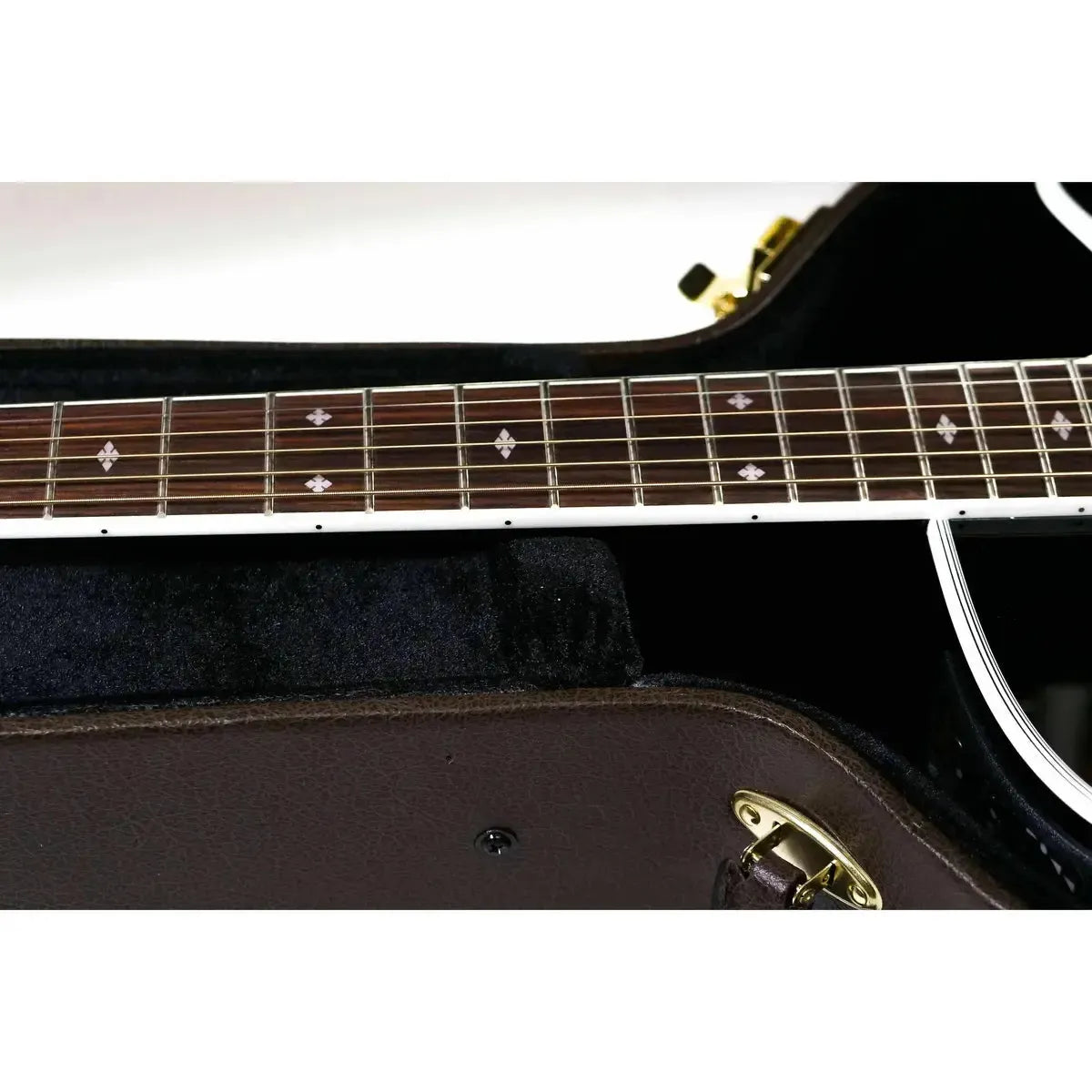 Takamine EF341SC acoustic-electric guitar fretboard with snowflake inlays in a brown hard case.