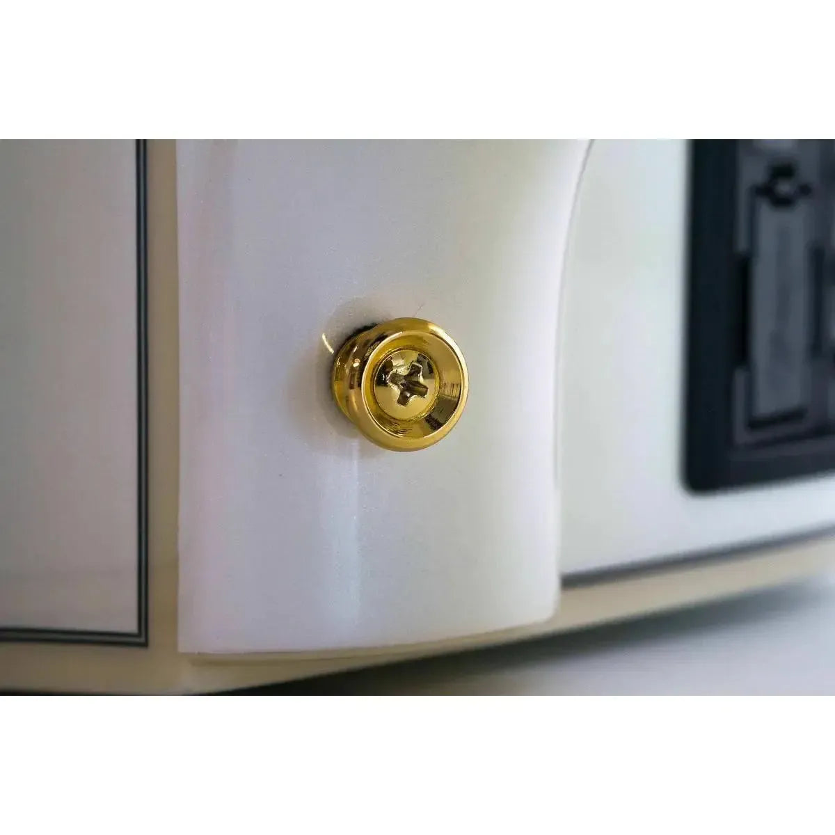Close-up of a Takamine GD37CE PW acoustic-electric guitar's gold strap button on its pearl white body.