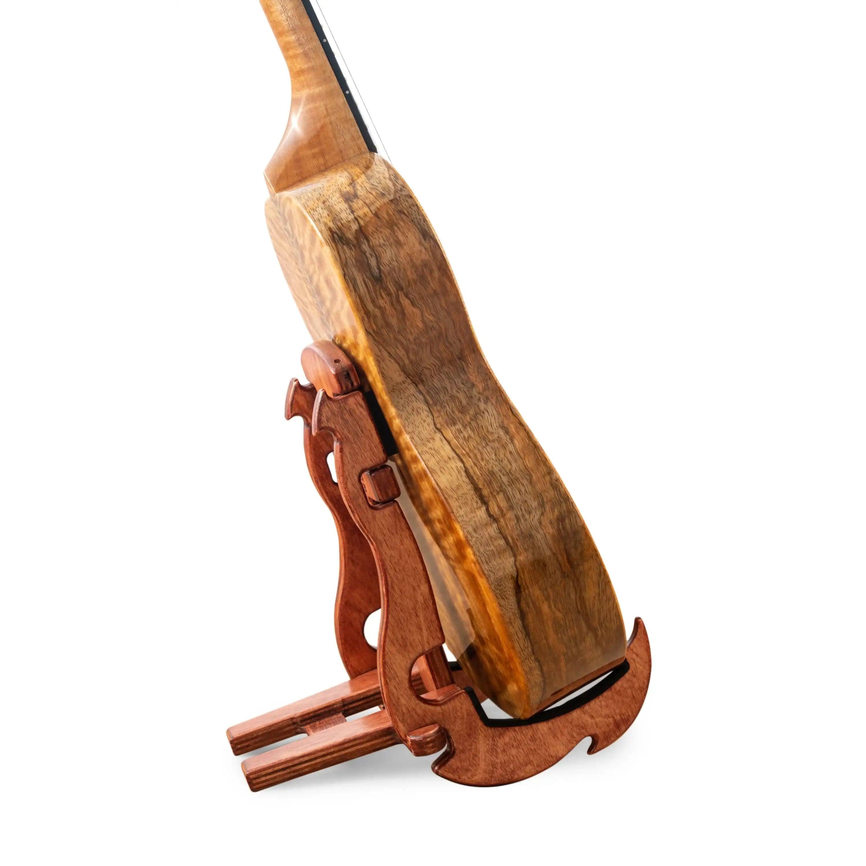 Wooden ukulele on matching wood stand with natural grain, Terry Carter Music Store