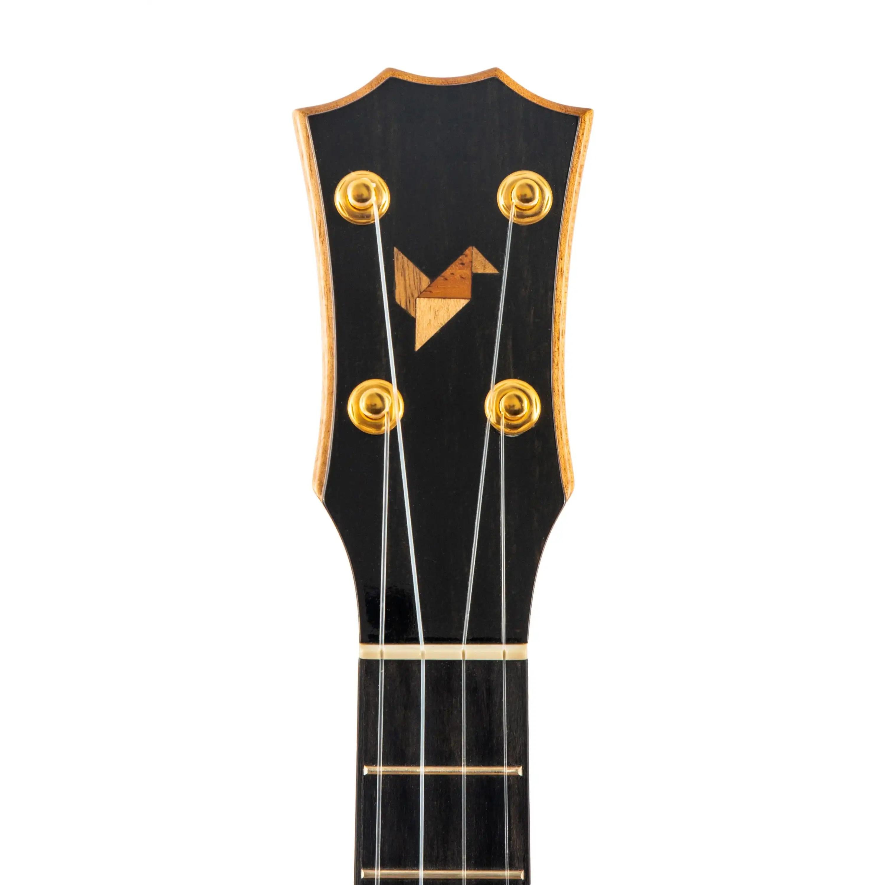 Ukulele headstock with gold tuners and wood inlay, black finish, at Terry Carter Music Store.