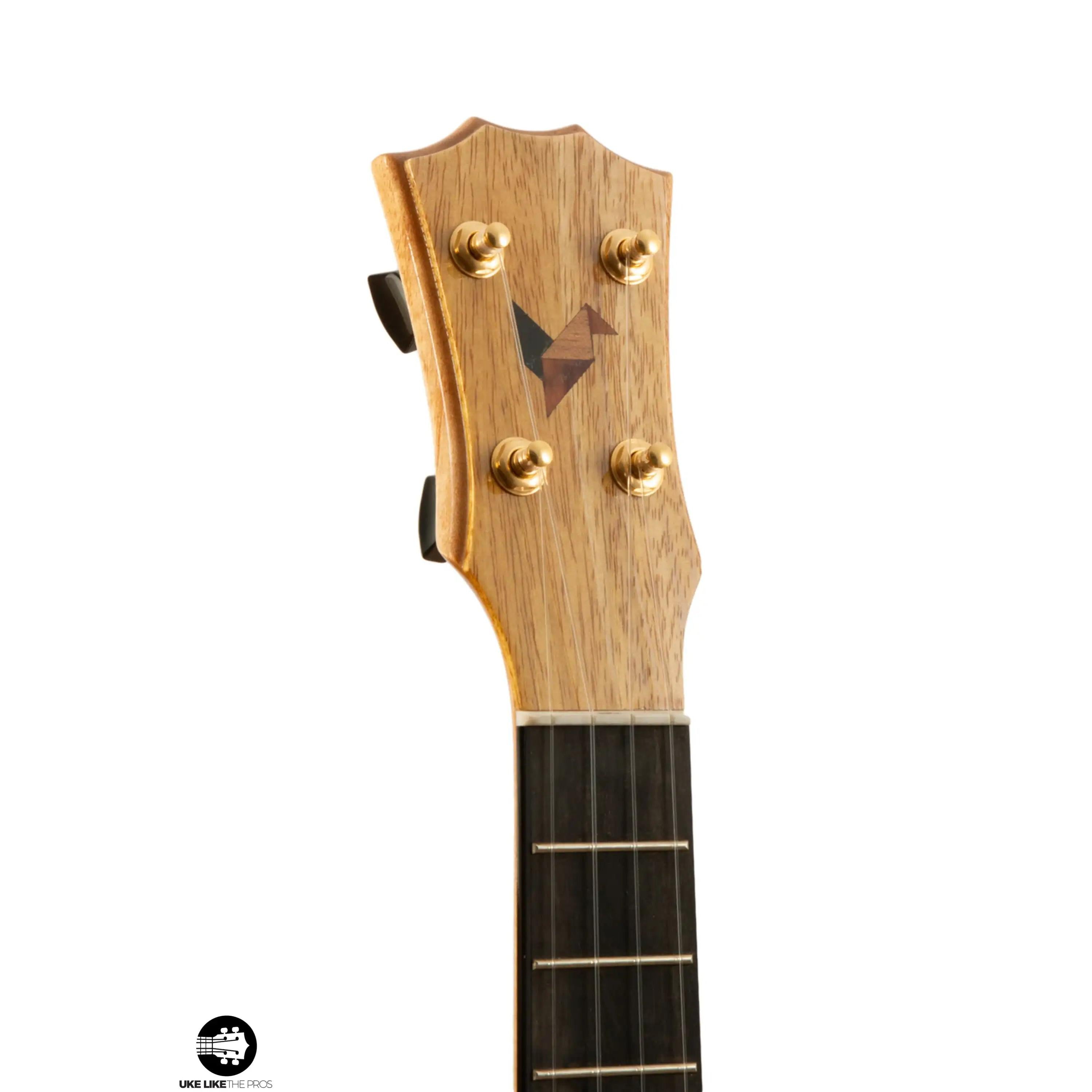 Romero Creations ukulele headstock with natural wood grain and gold tuners at Terry Carter Music Store