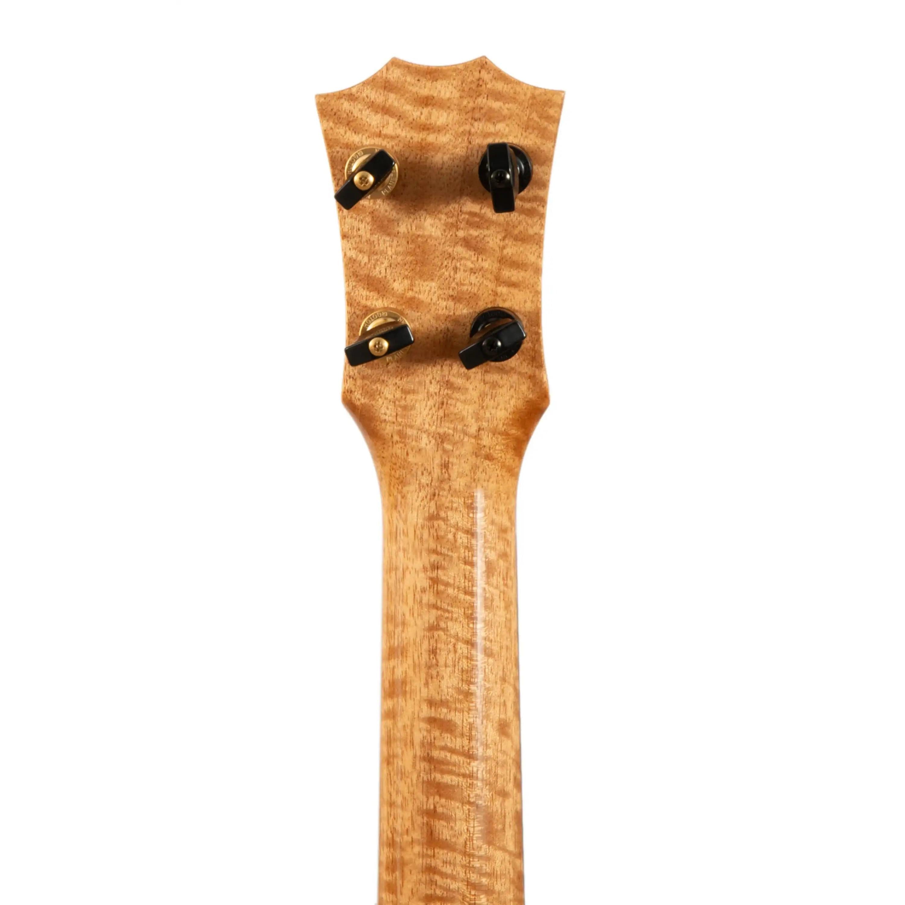 Figured wood ukulele headstock with gold tuners, visible at Terry Carter Music Store