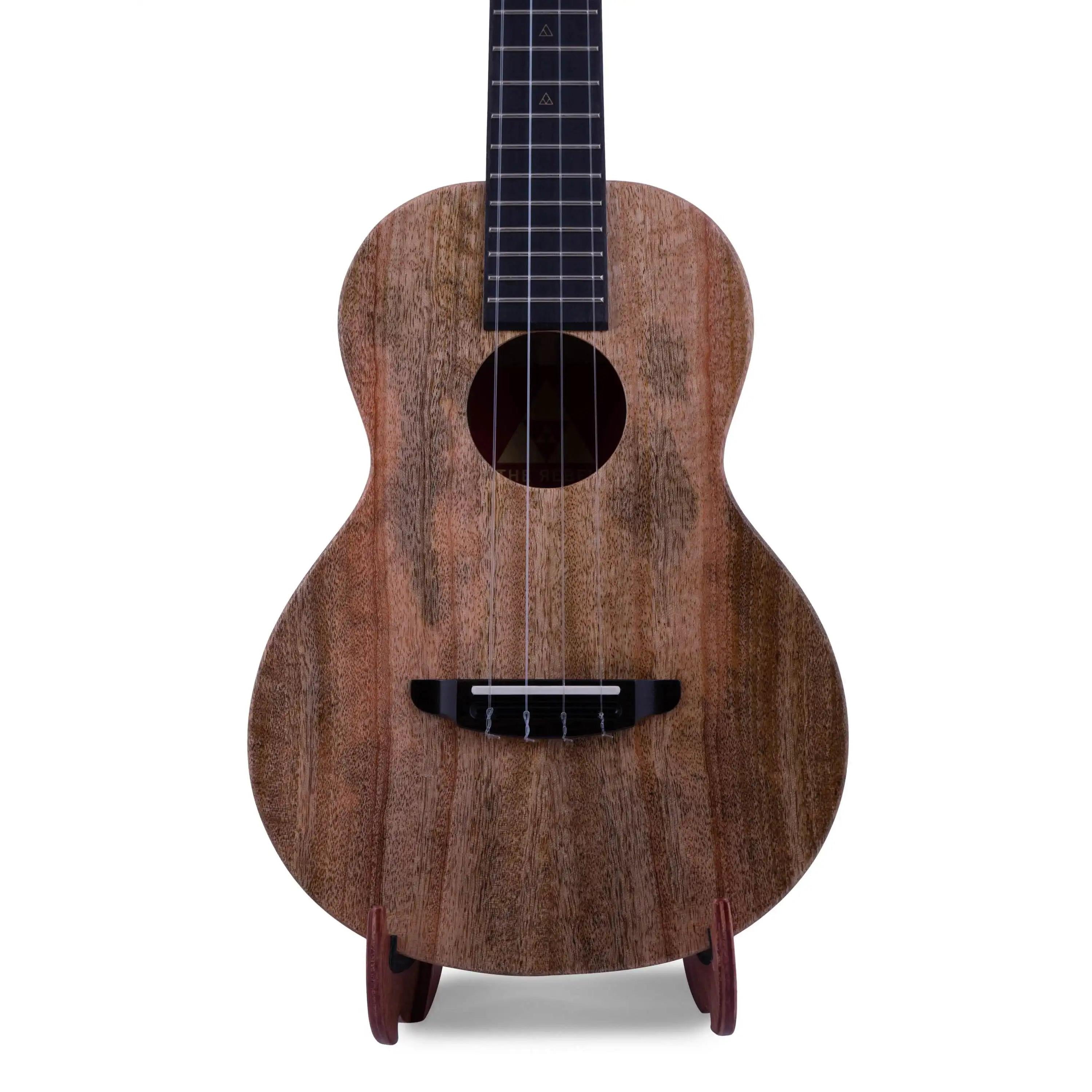 Rebel ukulele with natural matte wood finish, front view, on stand at Terry Carter Music Store